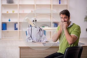 Young male patient visiting skeleton doctor