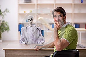 Young male patient visiting skeleton doctor