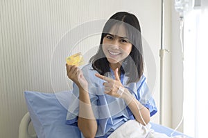 Young patient woman is holding credit card , admitting in hospital , Health care  concept