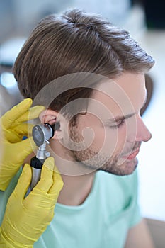 Young patients ear being examined with an auriscope