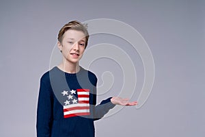 Young patriotic teenager wearing blue sweater with flag united states america