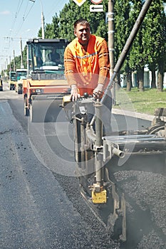Young paver worker at asphalting photo
