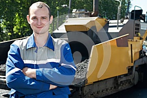 Young paver worker at asphalting