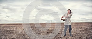 A young peasant sows the field with grain