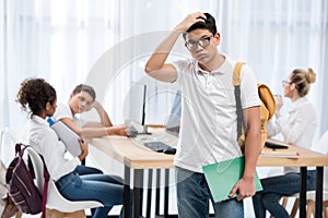 young pensive asian student boy in classroom