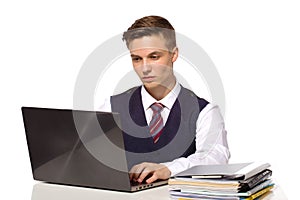 Young pensive businessman calculates taxes at desk in office.  on white