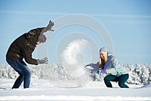 Young peolple playing with snow in winter