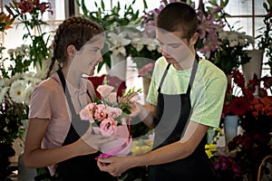 Young people arrange flowers in the flower shop