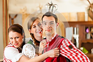 Young people in Bavarian Tracht in restaurant