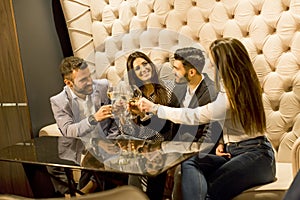 Young people celebrating and toasting with white wine