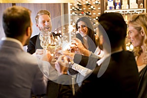 Young people celebrating and toasting with white wine