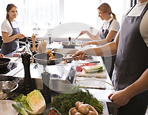 Young people during cooking classes in restaurant kitchen