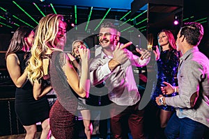 Young people dancing in night club