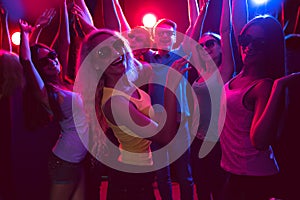 Young people dancing in a nightclub