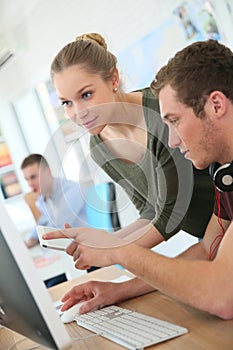 Young people on desktop computer studiing