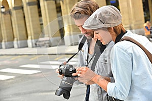 Young people doing photo reportage in town