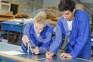 Young people doing technical drawing