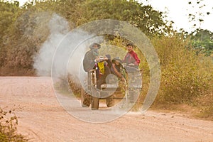 Young people driving a tractor