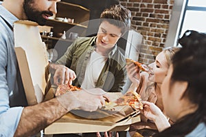 Young people eating pizza