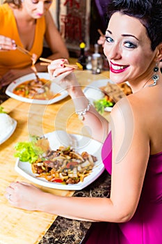 Young people eating in restaurant