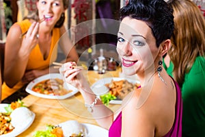 Young people eating in restaurant