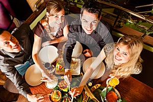 Young people eating in Thai restaurant
