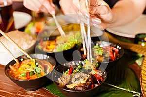 Young people eating in Thai restaurant