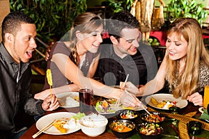 Young people eating in Thai restaurant