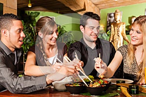 Young people eating in Thai restaurant