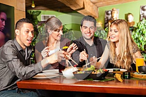 Young people eating in Thai restaurant