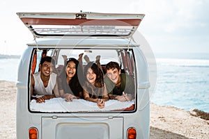 Young people enjoy holiday lay down relax inside vintage van