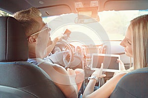 Young people enjoying a roadtrip in the car