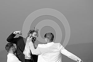 Young people fighting in nature on blue sky background