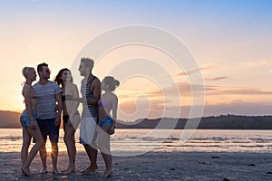 Young People Group On Beach At Sunset Summer Vacation, Happy Smiling Friends Walking Seaside