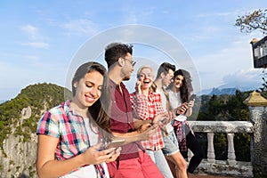 Young People Group In Mountain Using Cell Smart Phone Chatting Online Friends Asian Holiday Summer