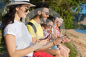 Young People Group Using Cell Smart Phones Tropical Park Palm Trees Friends Chatting Online Holiday Sea Summer Vacation