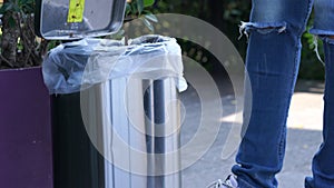 Young people hand dropping waste into recycle bin