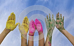 Young people hands covered in Holi Colors