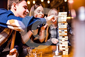 Young people have fun playing board games at a table