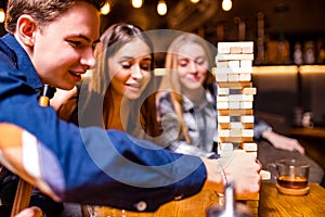 Young people have fun playing board games at a table