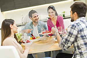 Young people have a meal in the dining room in modern home