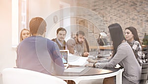 Young people having business meeting in conference room, view through glass