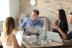 Young people having business meeting in office