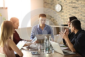 Young people having business meeting in office