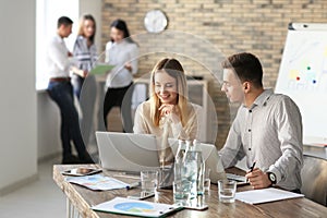 Young people having business meeting in office