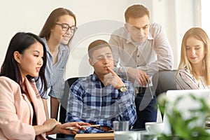 Young people having business meeting in office