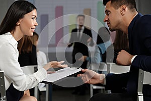 Young people having business training in room with projection screen