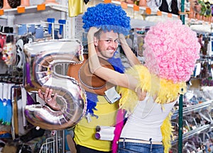 Young people are having fun in colorful clown wigs