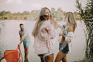 Young people having fun by river