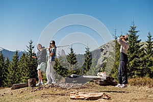 Young people hikers in roe deer clothes while walking in the mountains stand at a halt and plan to move on